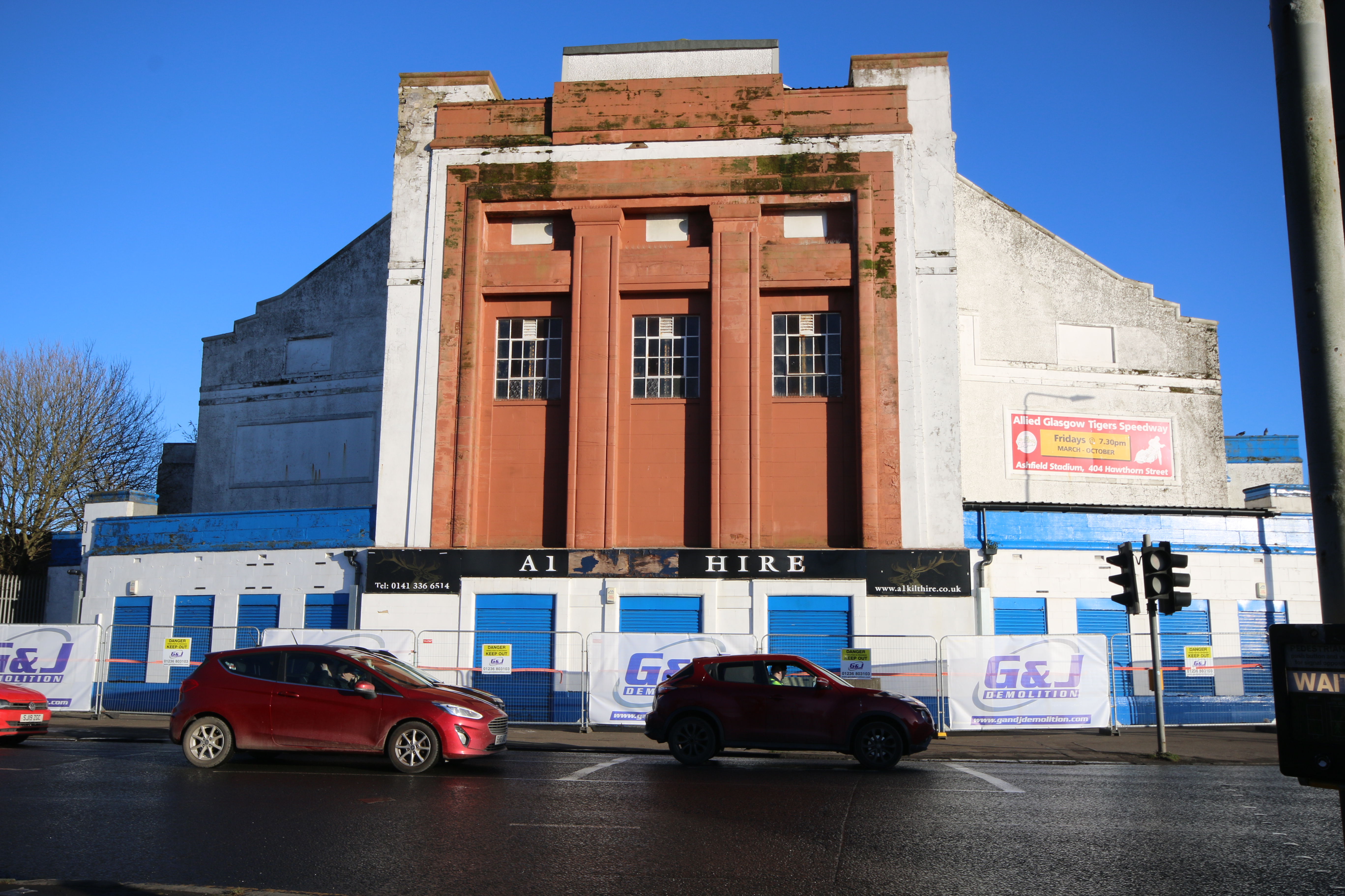 Principal elevation of the former Mecca Cinema on a bright, sunny day, with cars passing. 