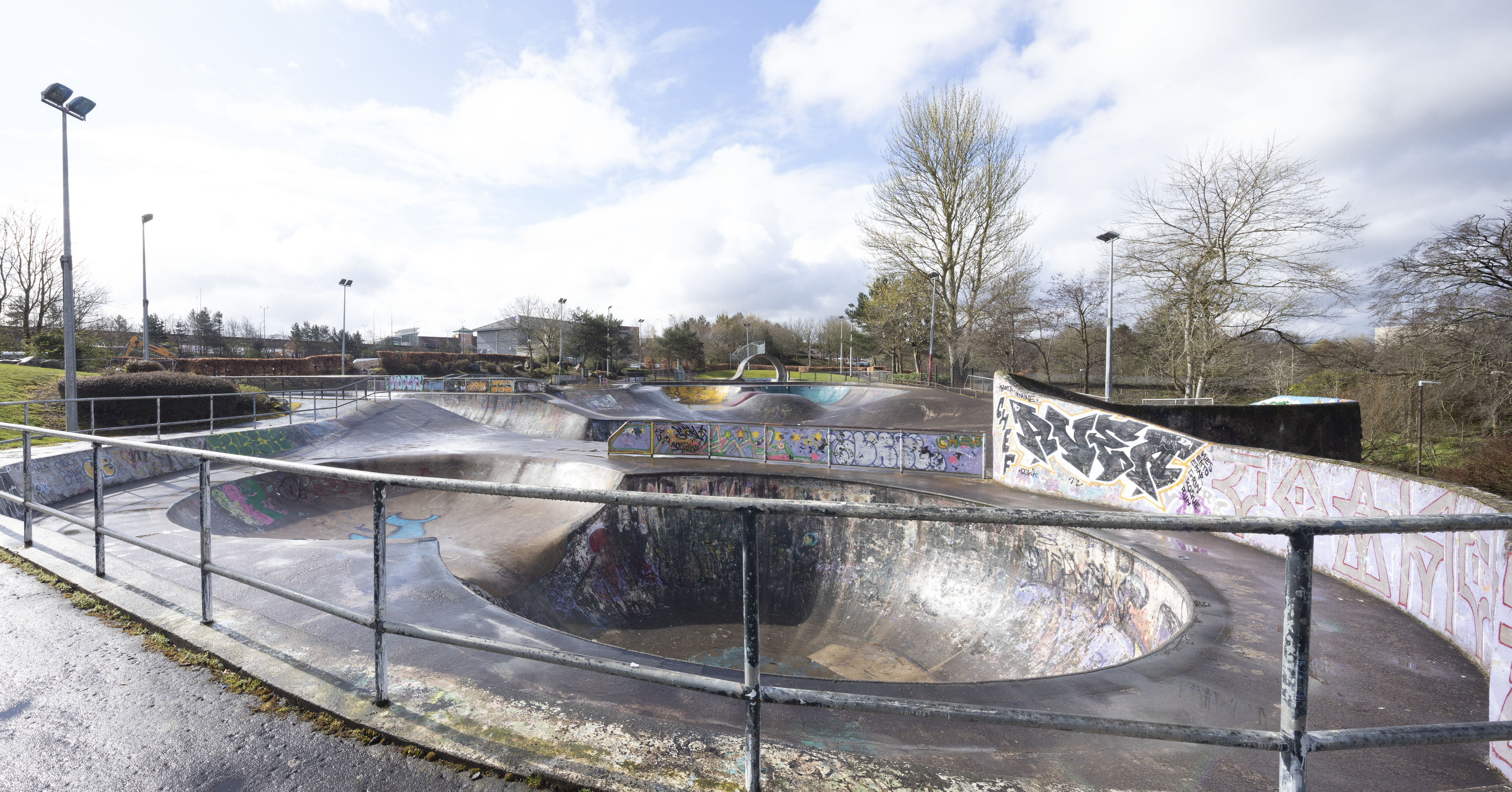 Concrete skatepark - railings foreground - grey sky background