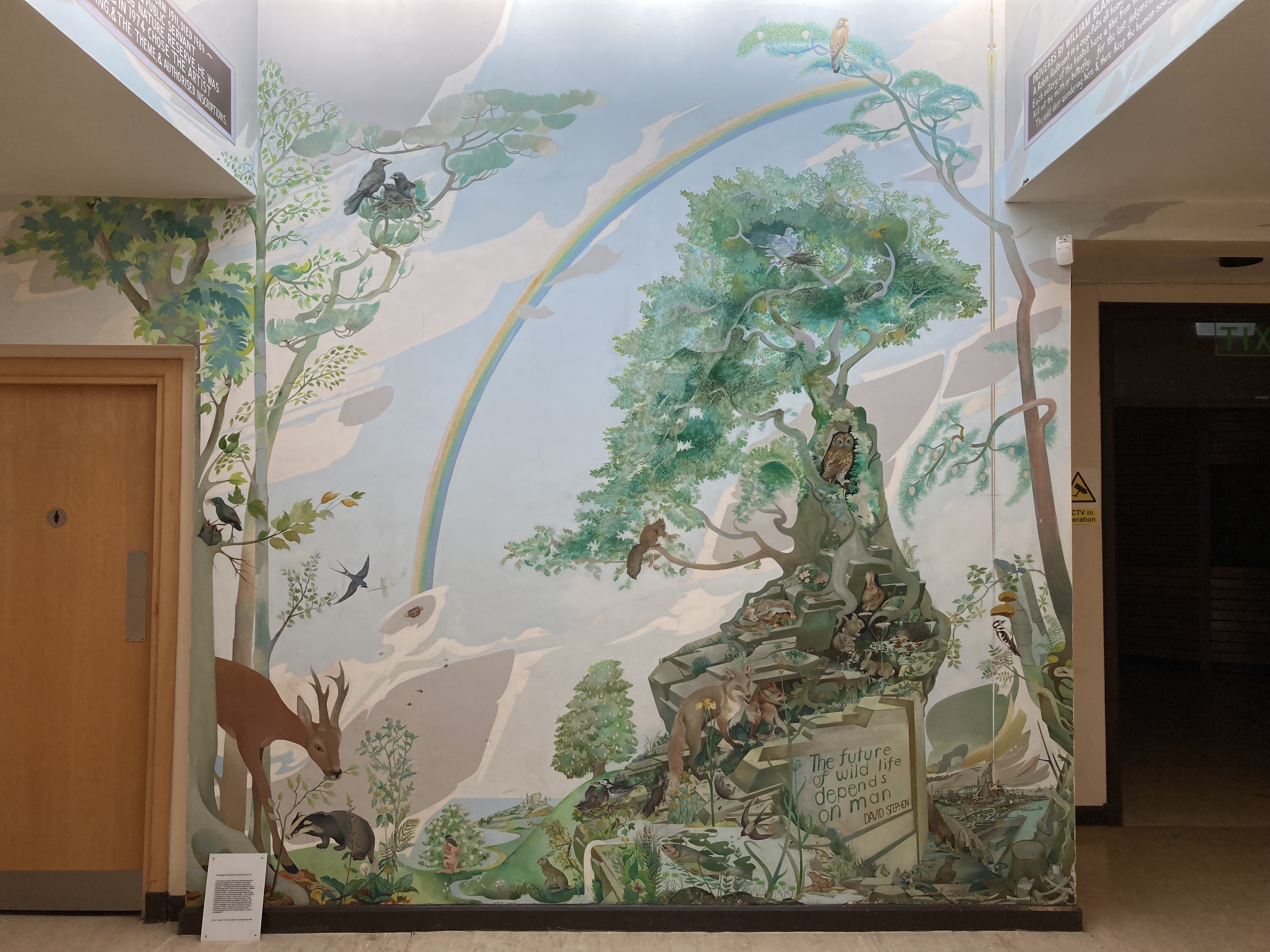 A mural depicting a countryside scene filled with wildlife including a deer