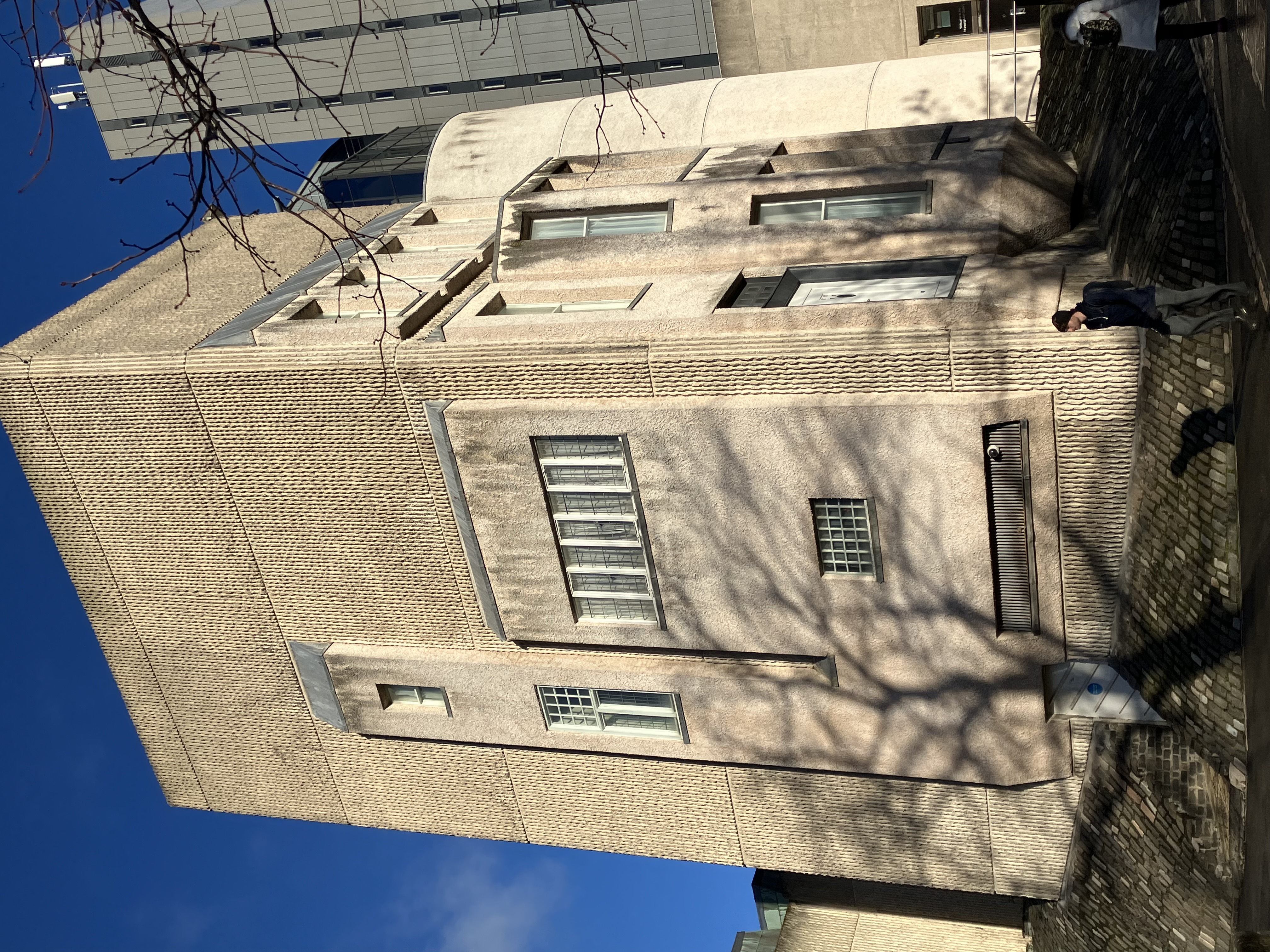Mackintosh House - tall cream coloured squared building against dark blue sky